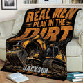 Construction truck blanket with rugged excavator artwork styled across a couch