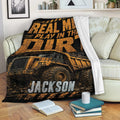 Construction dump truck blanket draped over a sofa with bold orange and black artwork