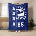 Blue volleyball throw blanket displayed in a living room with team-themed graphic artwork