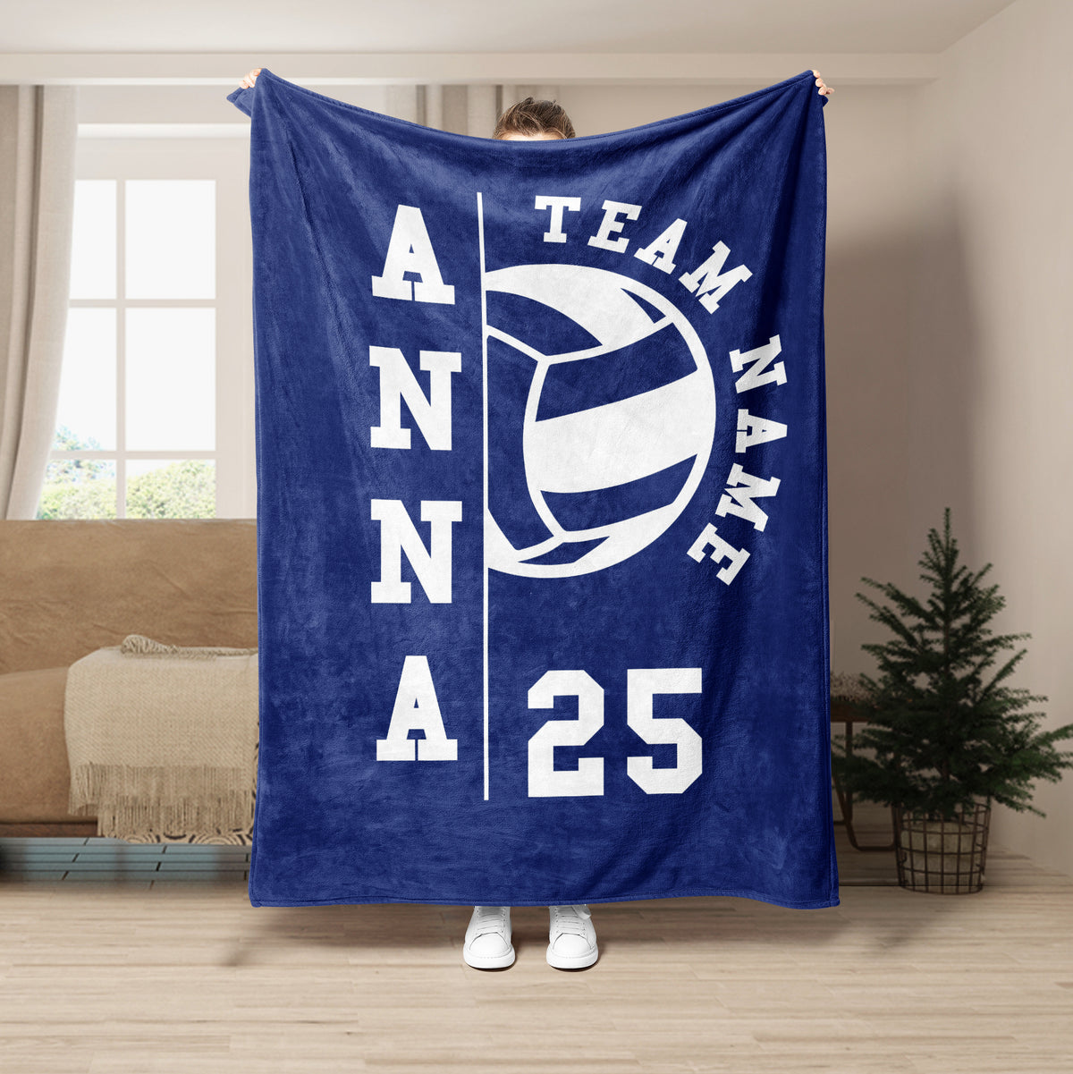 Blue volleyball throw blanket displayed in a living room with team-themed graphic artwork