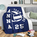 Volleyball throw blanket draped over a sofa for cozy sports-inspired living room decor