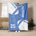 Blue football blanket held upright, featuring distressed white football graphics and jersey-style numerals