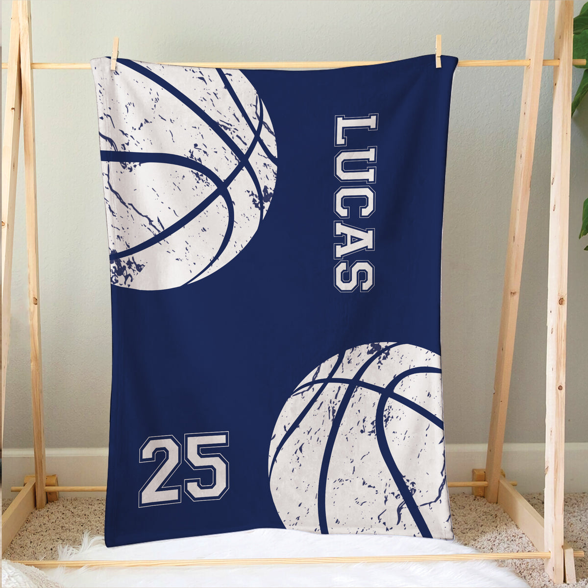 Navy basketball blanket displayed on a wooden frame with large distressed basketball graphics