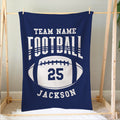 Blue football blanket hanging on a wooden frame with a large football graphic and athletic typography