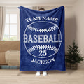 Navy baseball throw blanket shown hanging in a living room with bold white baseball artwork