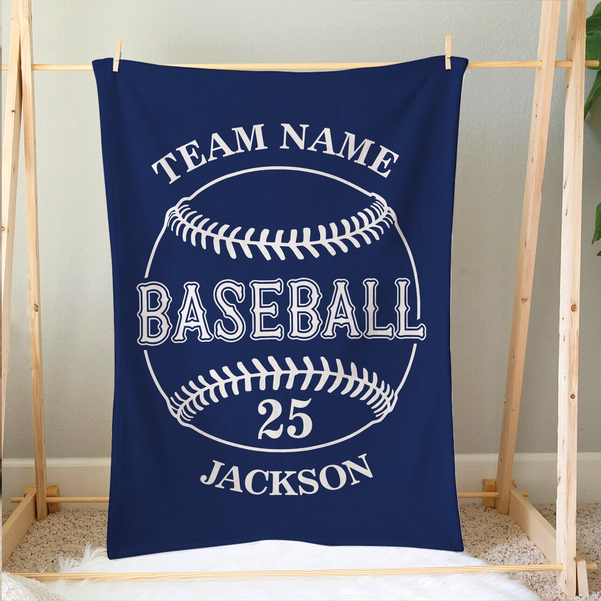 Navy baseball blanket displayed on a wooden frame with classic baseball stitching design