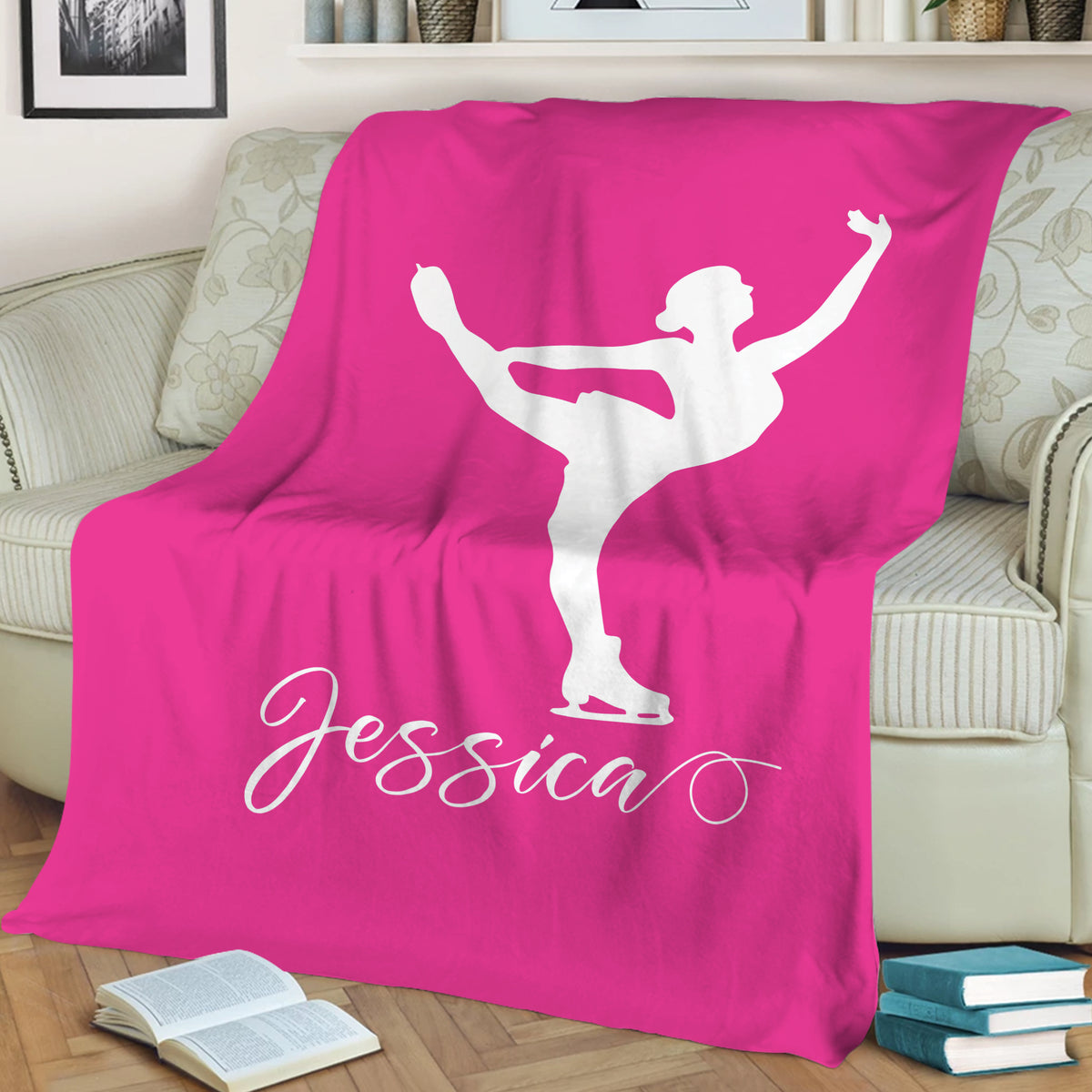 Pink ice skating blanket draped over a sofa with a white figure skater silhouette