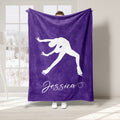 Purple ice skating blanket featuring a white figure skater silhouette in an extended pose