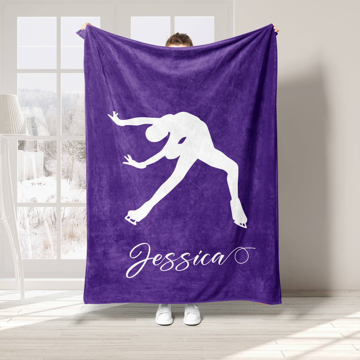 Purple ice skating blanket featuring a white figure skater silhouette in an extended pose
