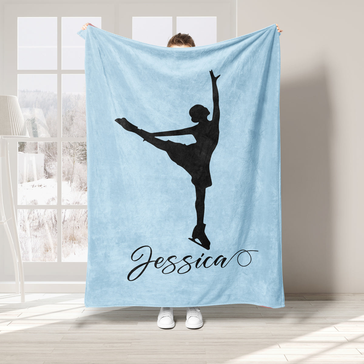 Light blue ice skating blanket featuring a black figure skater silhouette in an elegant pose