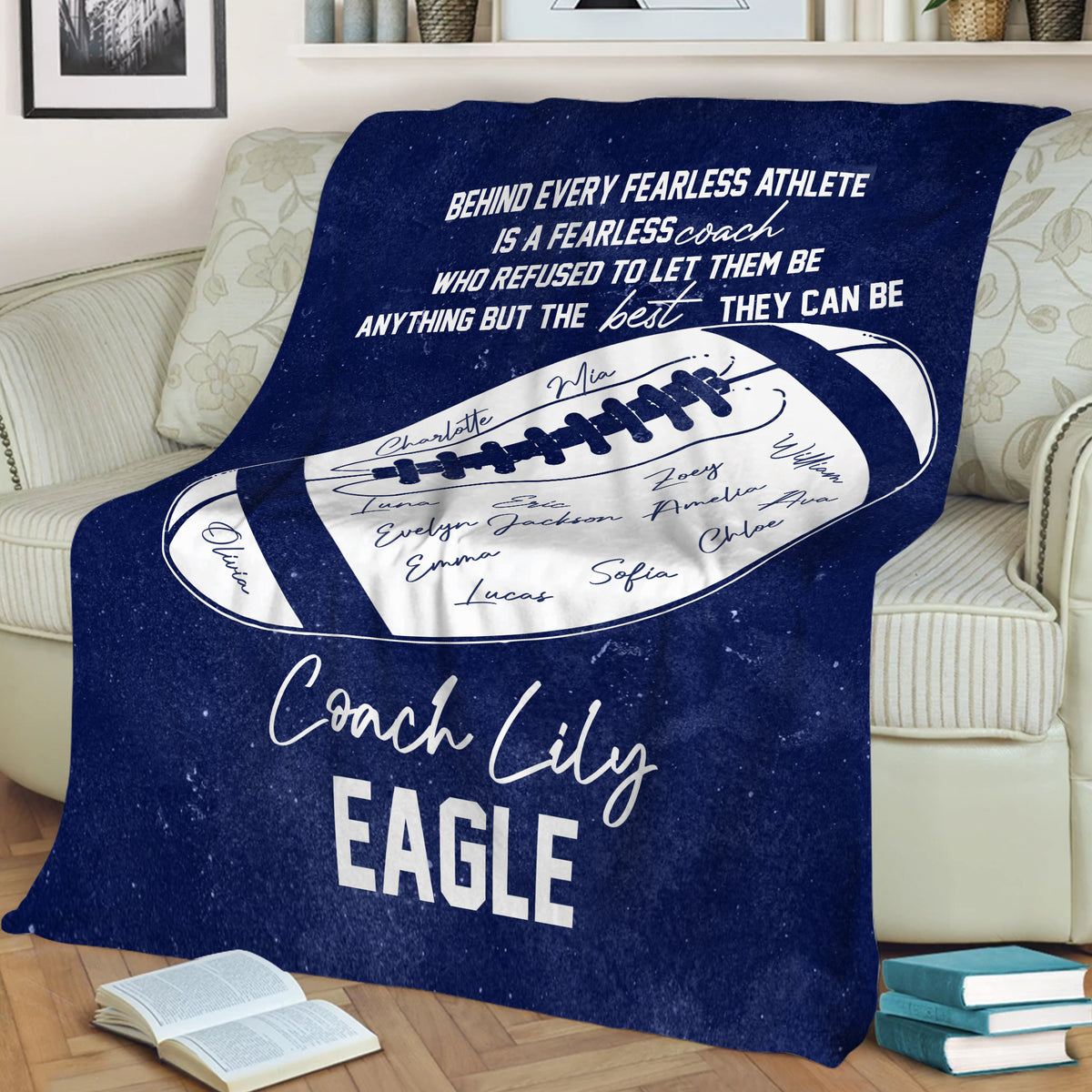 Navy football throw blanket draped over a sofa with coach appreciation artwork