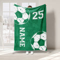 Green soccer throw blanket with oversized ball artwork and white athletic-style graphics