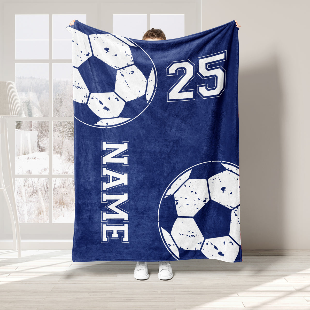 Navy blue soccer blanket featuring large soccer balls and bold white sports graphics