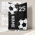 Black soccer throw blanket with distressed ball graphics and bold athletic-style design