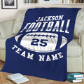 Blue football throw blanket draped over a couch with bold sports lettering and football artwork