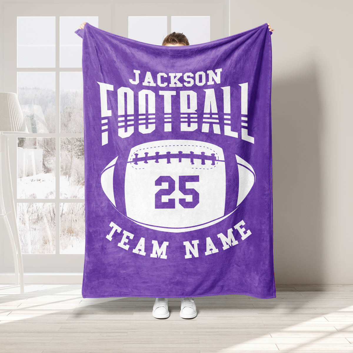 Purple football throw blanket featuring bold white sports lettering and a large oval football design
