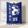 Navy blue soccer throw blanket with a large white soccer ball graphic and bold athletic typography