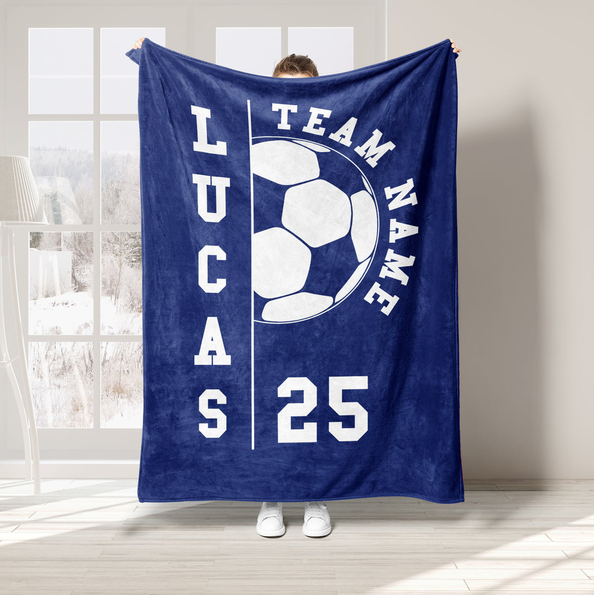 Navy blue soccer throw blanket with a large white soccer ball graphic and bold athletic typography