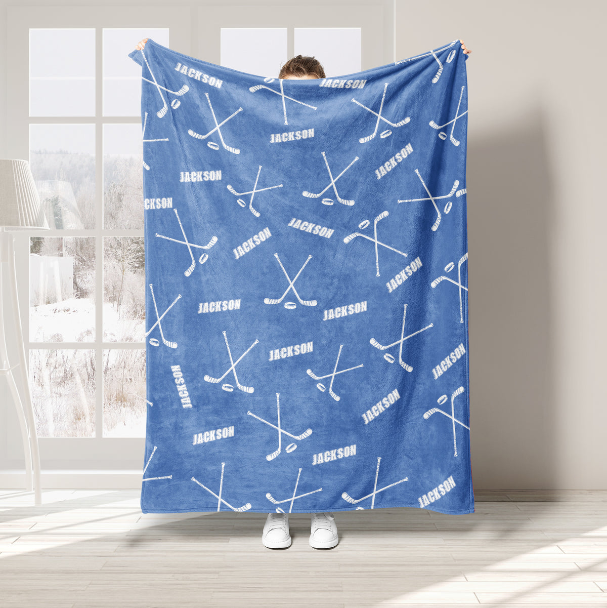 Light blue hockey throw blanket displayed with white sticks and puck pattern