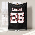 Black baseball throw blanket featuring white jersey-style artwork with red baseball stitching