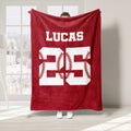 Red baseball throw blanket featuring bold jersey-style artwork with baseball stitching accents