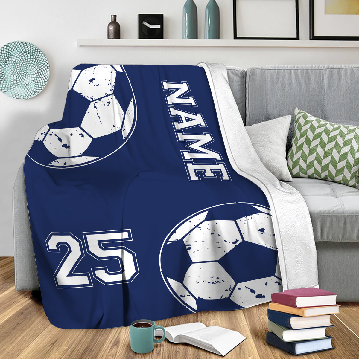 Blue soccer blanket draped over a sofa with oversized ball graphics and bold athletic-style details