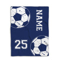 Blue soccer blanket shown flat with large distressed soccer balls and strong navy and white sports artwork