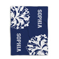 Blue cheerleading blanket shown flat with large white pom-pom graphics and athletic block lettering