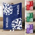 Cheerleading throw blanket displayed in blue, red, green, and purple color options with pom-pom artwork