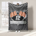 Orange checkered flag racing throw blanket with metallic flagpoles and geometric sports artwork