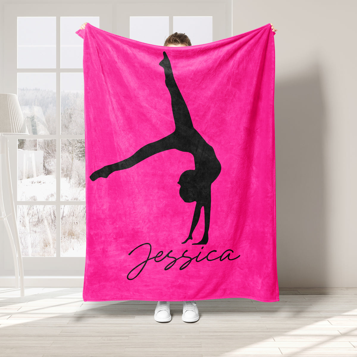 Bright pink gymnastics blanket featuring a black silhouette performing an extended pose