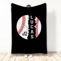 Black baseball throw blanket with bold white baseball graphic and red stitching