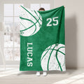 Green basketball throw blanket with white basketball artwork and bold varsity-inspired graphics