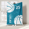 Teal basketball blanket featuring oversized white basketball graphics and athletic block design