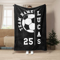 Black soccer blanket displayed as a full throw with a large white and black soccer ball design