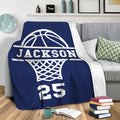 Navy basketball throw blanket draped over a sofa in a cozy living room setting
