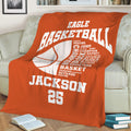 Orange basketball blanket draped over a sofa with large basketball graphics and sporty room decor