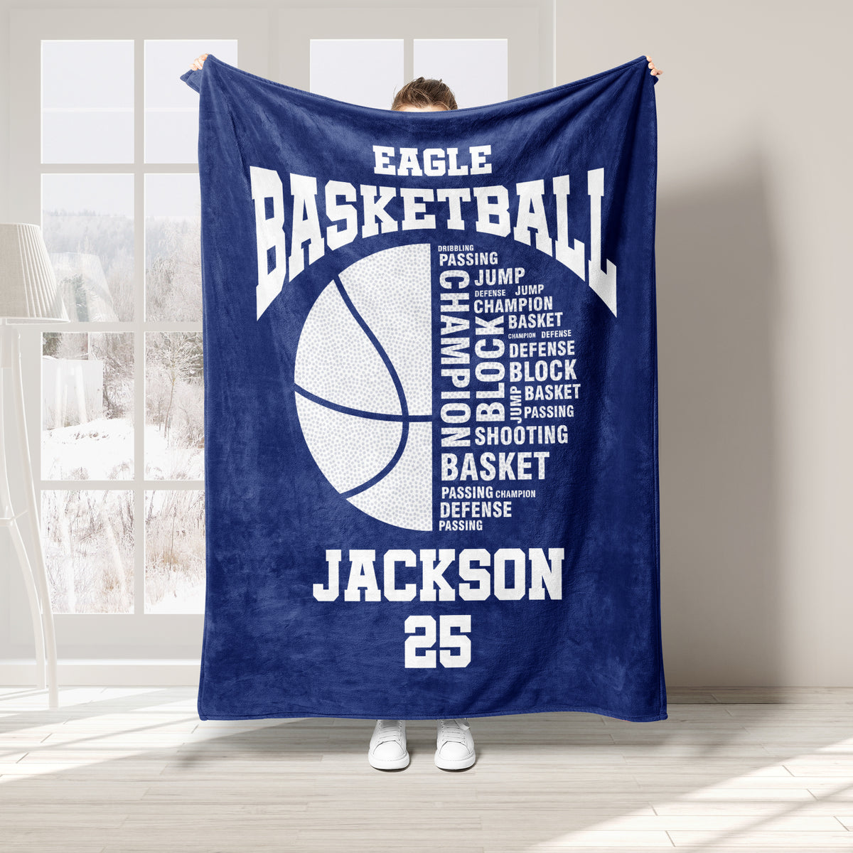 Navy basketball throw blanket shown indoors with bold basketball artwork and sports typography