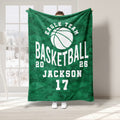 Green camouflage basketball throw blanket displayed in a bright room with bold white sports artwork