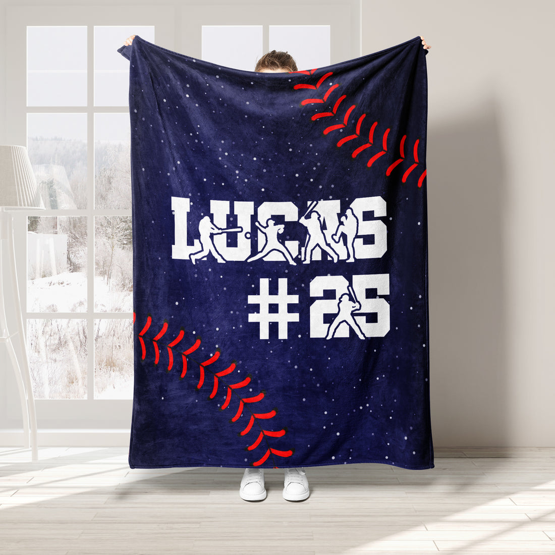 Baseball throw blanket displayed with white player silhouettes, red stitching details, and navy sports artwork