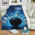 Bowling throw blanket draped over a sofa with black ball, pins, and dramatic blue flame artwork