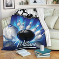 Bowling blanket draped over a sofa with blue bowling ball and pin artwork