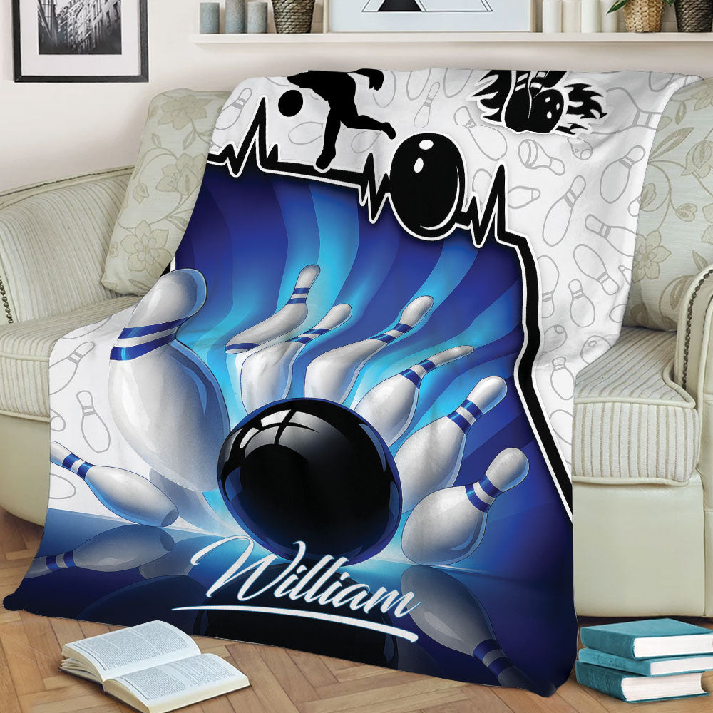 Close view of bowling throw blanket featuring a bowler silhouette, ball, and pins