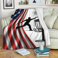 Disc golf throw blanket displayed on a sofa with patriotic flag stripes and basket artwork