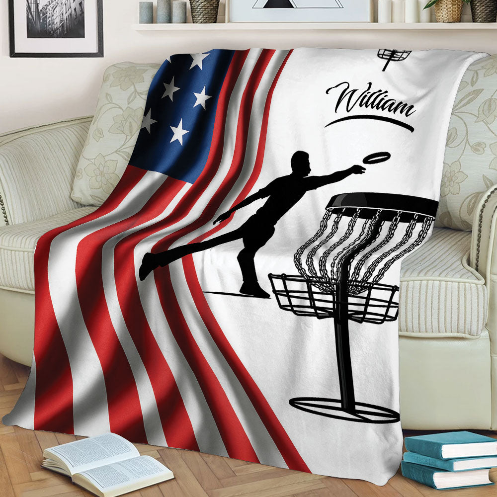 Patriotic disc golf blanket draped over a sofa with player silhouette and disc basket design