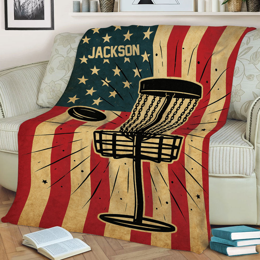 Disc golf blanket draped over a couch featuring a basket and flying disc design