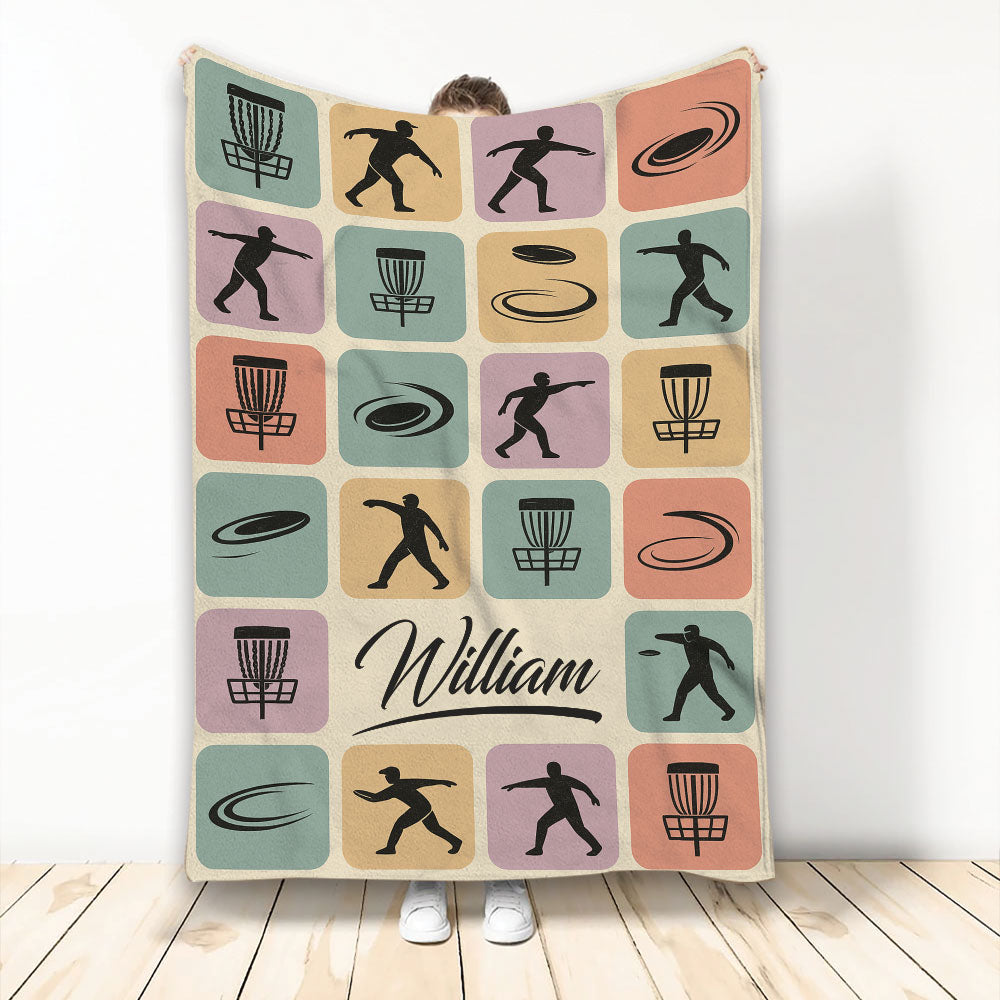 Custom Disc Golf blanket with colorful retro squares, disc golf baskets, flying discs, and player silhouettes