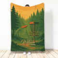 Disc golf blanket featuring a basket, flying disc, and forest course artwork in green and orange tones