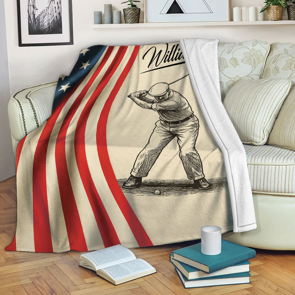 Golf blanket draped over a sofa, showing a golfer sketch and patriotic red, white, and blue design