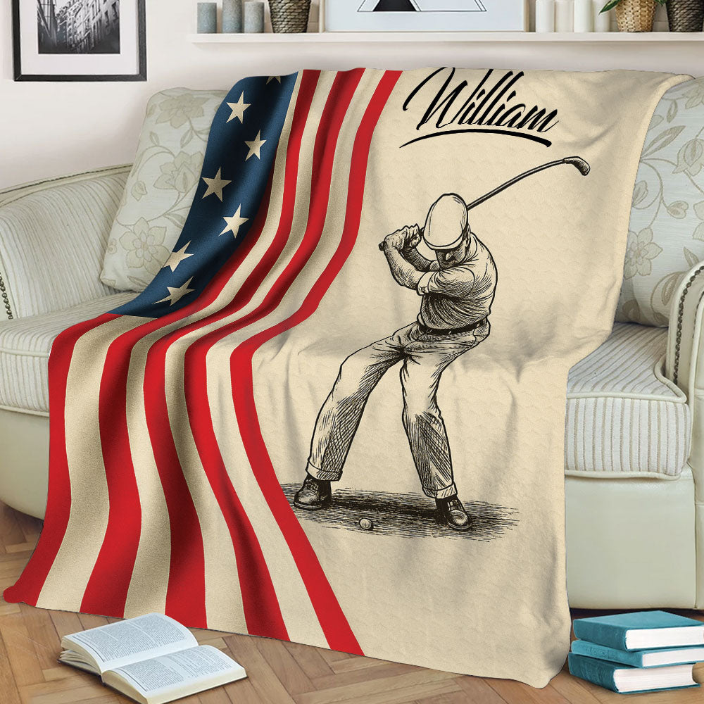 Patriotic golf throw blanket displayed on a sofa with a detailed golfer swing illustration